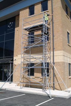 Mobile aluminium scaffold used by electrician indoors