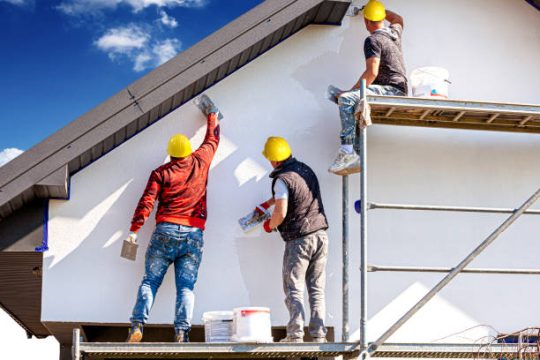 Workers using kwikstage scaffolding to plaster a residential house exterior in Australia