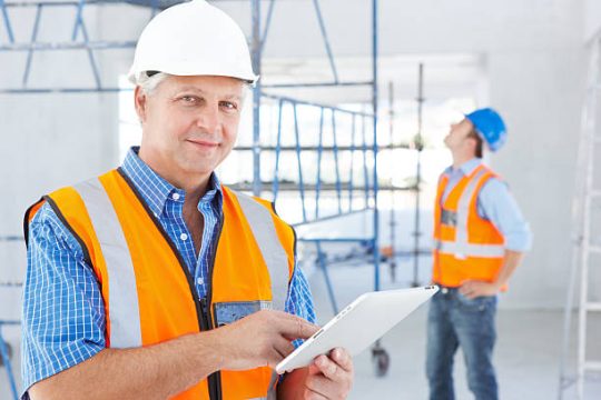 Site supervisor inspecting scaffolding area during maintenance project