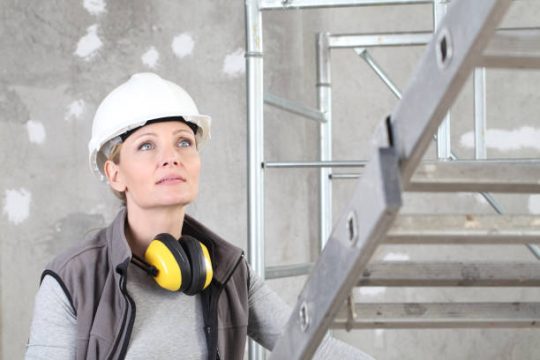 worker in safety helmet inspecting access setup near kwikstage scaffolding by GW Equip