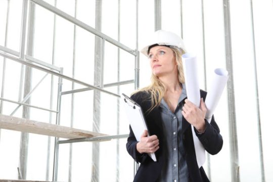 Construction worker checking scaffold setup and site access with safety documents