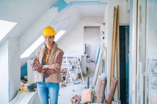 Builder inspecting an unfinished interior during a modular construction project