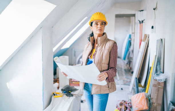 Builder reviewing renovation plans before selecting scaffold access equipment