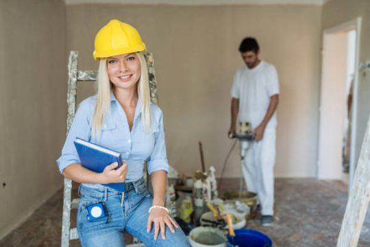 Construction supervisor checking renovation site safety and scaffold requirements